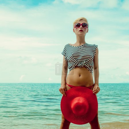 Fashion portrait of a girl on the sea