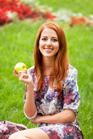Girl with apple at outdoor