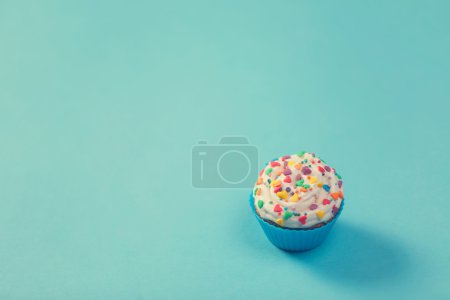 Cupcake on color background.