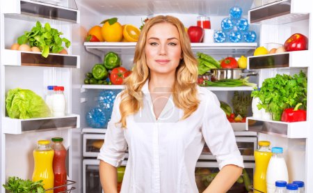 Healthy woman near open fridge