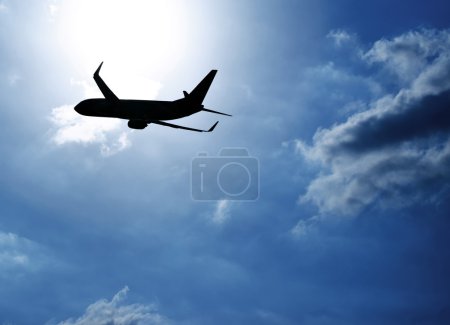 Silhouette airplane in blue sky