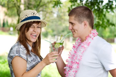 Cute couple drinking mojito coctail