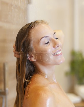 Relaxed woman under the shower