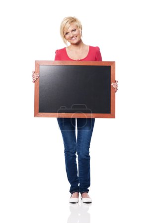 Smiling woman holding blackboard