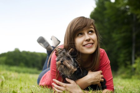Young woman holding Yorkshire terrier