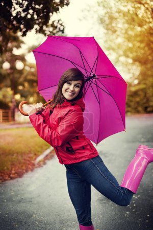 Young woman under pink umbrella