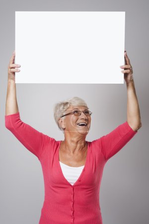 Senior woman holding whiteboard