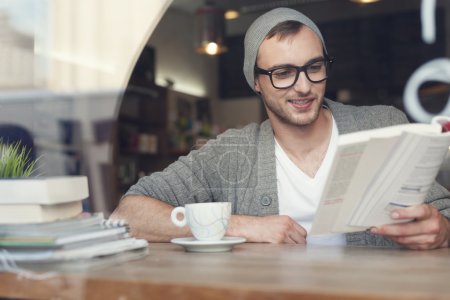 Hipster man reading book