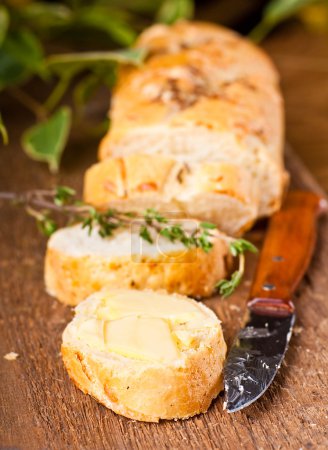 Fresh bread and butter on a wooden board