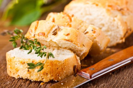 Fresh bread and butter on a wooden board