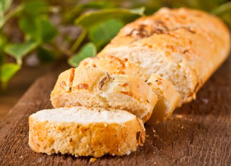 Fresh bread and butter on a wooden board