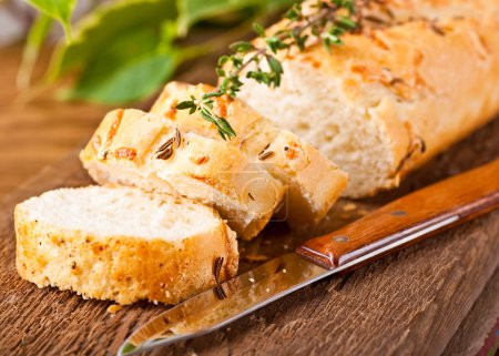 Fresh bread and butter on a wooden board