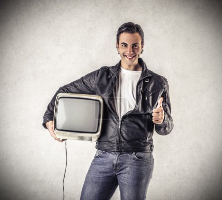 Smiling man holding television