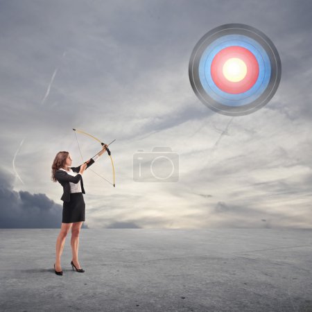 Business woman throwing an arrow