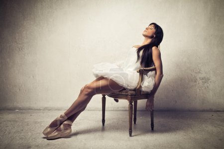 Dancer relaxing sitting on a chair