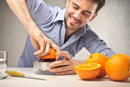 Man squeezing an orange