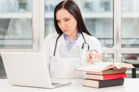 Female doctor is studying with books