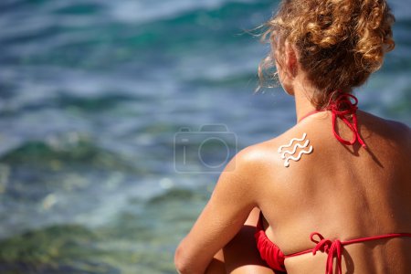 Woman with suntan lotion