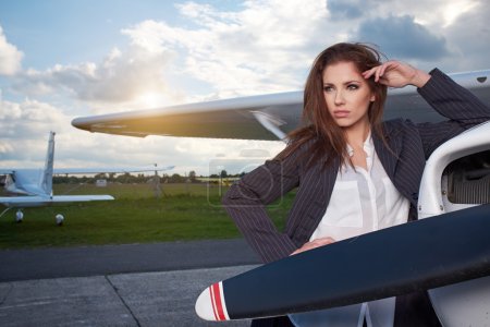 Businesswoman standing by his private plane