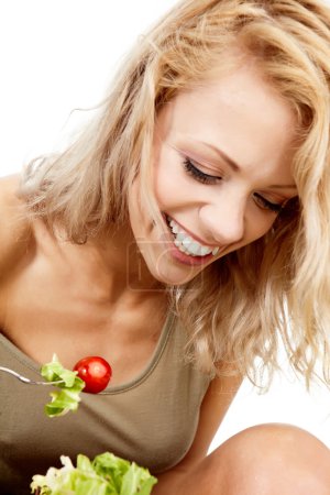 The young beautiful woman with the fresh vegetables