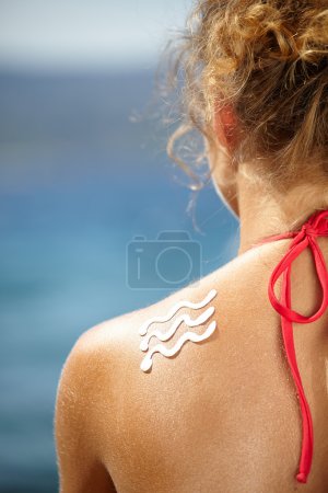 Girl back with sun lotion