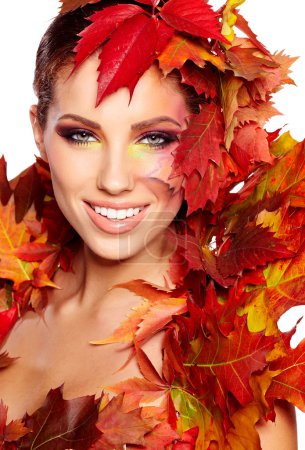 Beautiful woman with autumn leaves on white background