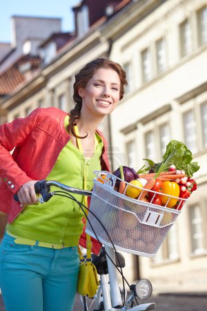 Spring woman with bicycle and groceries