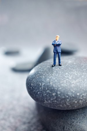 Business miniature figures and rocks