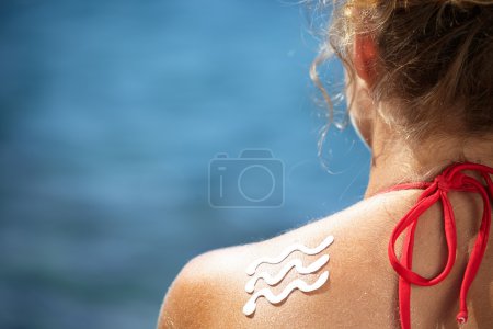 Girl back with sun lotion