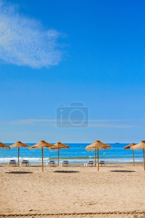 Sun umbrella with chair longues on tropical beach