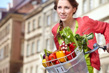 Woman with bicycle and groceries