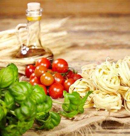 Raw pasta,vegetables ,olive oil and spices 