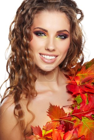 Beautiful woman with autumn leaves on white background