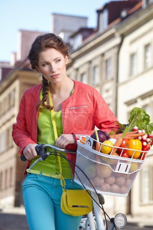 Spring woman with bicycle and groceries
