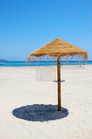 Tropical beach scenery with parasol