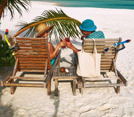 Couple in green on a beach at Maldives