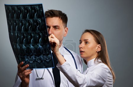 Medical doctors team with MRI spinal scan