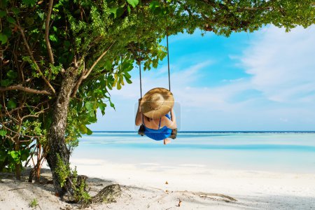 Woman swinging at beach