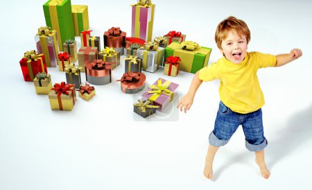 Amazed little boy with lots of presents