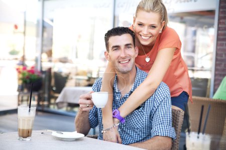 Photo of relaxed couple in coffee shop