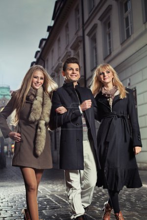 Elegant gentleman with two girls