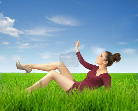 Attractive lady lying on grass
