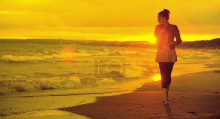 Art picture of woman, waves and sunset