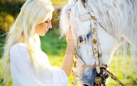 Sensual blonde nymph and majestic horse