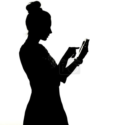 Silhouette of a woman uisng the smartphone