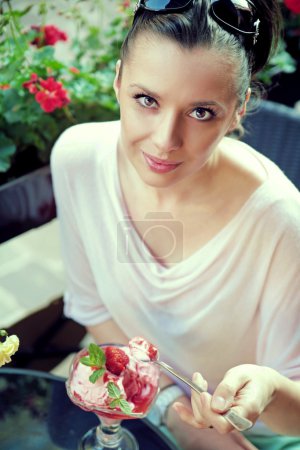 Pleased brunette woman with fine dessert