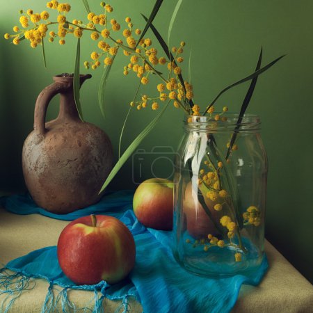 Still life with mimosa flowers and apples
