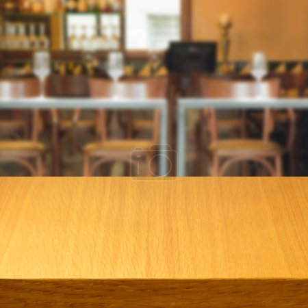 Empty wooden table inside restaurant