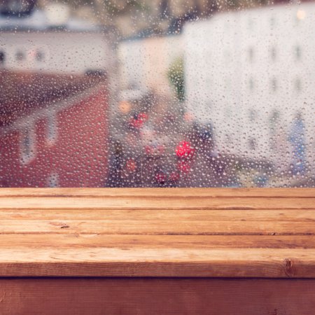 Table over window with rain drops