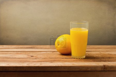 Fresh orange juice on vintage wooden table